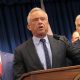 Robert F. Kennedy Jr. speaking at a podium with supporters in the background during a pr — FDA abortion pill safety review