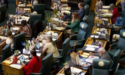 Women Running for State Legislature represented among lawmakers seated at desks in a legislative chamber