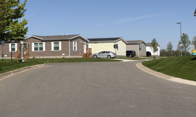 Quiet street lined with manufactured homes and parked cars — Manufactured Home Chassis Federal Law