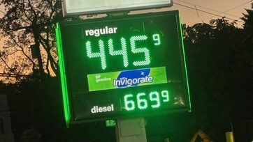 Gas station price board showing rising fuel costs with regular gasoline at $4.45 and diesel at — Inflation Rate September