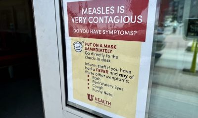 A sign warning about the contagious nature of measles, instructing people to wear masks an — Pennsylvania Measles Outbreak