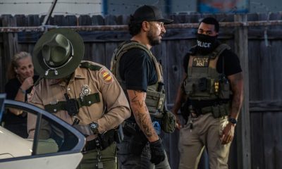 Law enforcement officers in tactical gear conducting an operation related to imm — 287g Agreements Immigration Enforcement