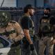Law enforcement officers in tactical gear conducting an operation related to imm — 287g Agreements Immigration Enforcement