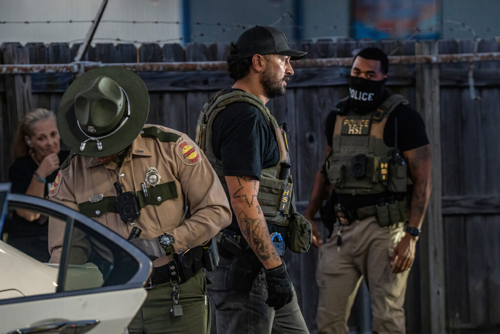 Law enforcement officers in tactical gear conducting an operation related to imm — 287g Agreements Immigration Enforcement