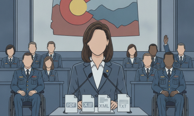 A woman in a suit stands at a podium with documents, addressing an audience of veteran — Veterans Mental Health Access Act